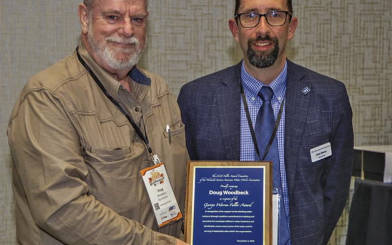 (Courtesy Photo) Gordon resident and City Council member Doug Woodbeck receives the George Warren Fuller Award from AWWA Vice-President John Eisnor, who came from Halifax, Nova Scotia to visit the conference.