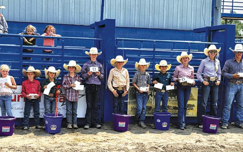 Photo by Courtney Ostrander The participants lined up following all the events during the 2024 Junior Rodeo to show off the hardware they earned in the arena. Those pictured include: (L-R) Myah Burress, Brookley Peters, Connor Peters, Weston Rahn, CoBurn Morrison, Payton Burress, Shaylee Grant, Truett Kearns, Tru Mundorf, Audrabell Werth, Sutten Parkison, Matthew Lein, and Bentley Ford.