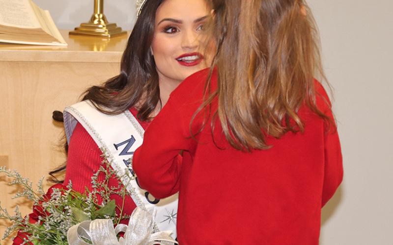 (Photo by Scott Bidroski) A young fan visits with Miss USA Audrey Eckert during her visit to Gordon on Friday, December 26.