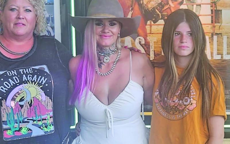 (Courtesy Photo) At the premiere event for East of Wall, Gordon Livestock owner Patsy Tines (left) takes a photo with the stars of the film, Tabatha Zimiga (center) and Porshia Zimiga (right).