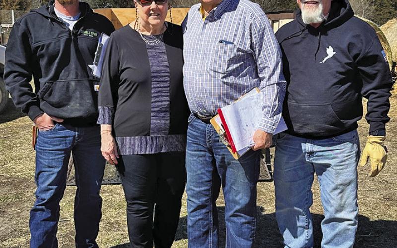 (Photo by Heidi Beguin) Zane Baldwin, Carol Nickolisen, Gary Ruse, and Jim Baldwin pause for a photo as pheasants were being delivered to their new homes.