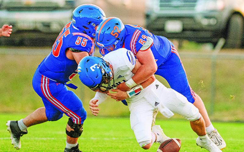 Photo by Morgan Meisenheimer Senior Maddox Leeper lowers the boom on O’Neill QB Turner Heiss. Leeper would get the sack and the forced fumble for his efforts on this play.