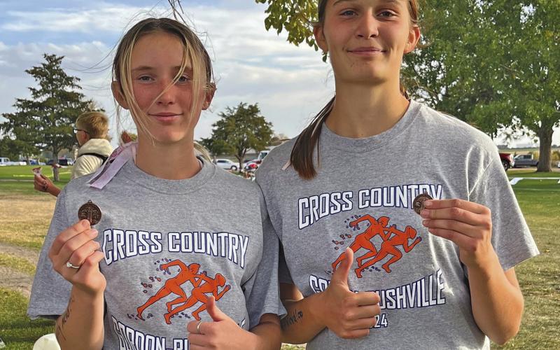 Photo by Amy Schmidt Kynsleigh Krebs (left) and Ashlyn Dehning (right) each medaled and earned a trip to State XC this Friday.