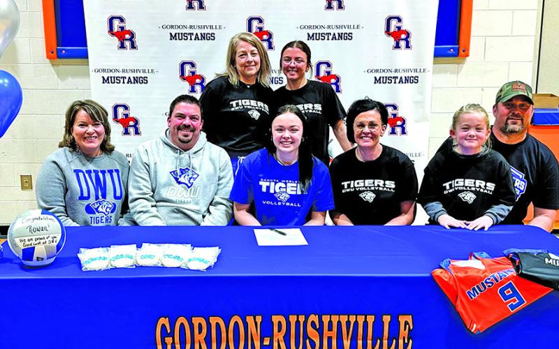 (Photo by Scott Bidroski) Gordon-Rushville High School senior Rowan Simonson made her collegiate sporting dreams come true this past week by signing her letter of intent to play volleyball at Dakota Wesleyan University. Simonson put ink to paper with her family and friends on Tuesday, December 16. Those pictured include (L-R) Kori Simonson, Nic Simonson, Rowan Simonson, Brooke Simmons, Sutton Simmons, and Justin Simmons. In the back row is Head GRHS Volleyball Coach Kim Campbell and Reese Simonson.