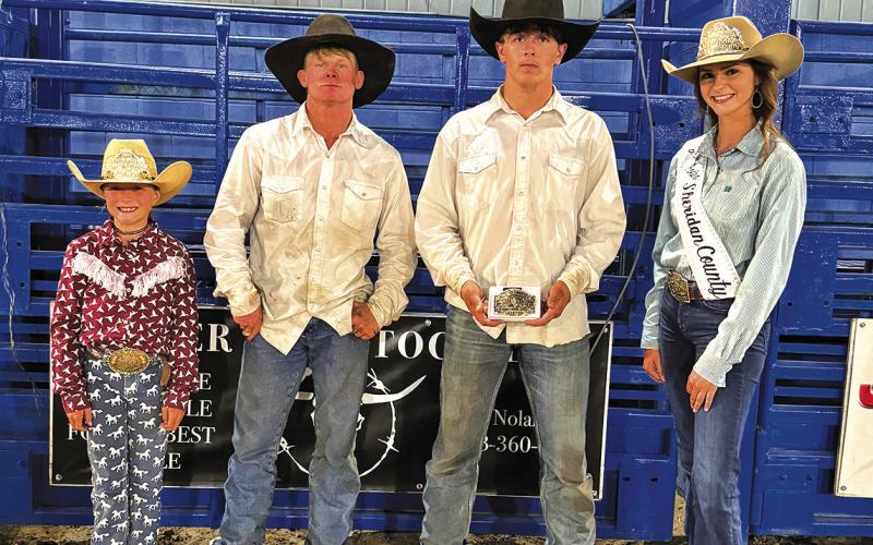 Photo by Courtney Ostrander Teegan Dedus, second from right, took home the top prize in the Ranch Bronc Riding event on Tuesday, July 23. Beau Lake, second from left, took home second place.