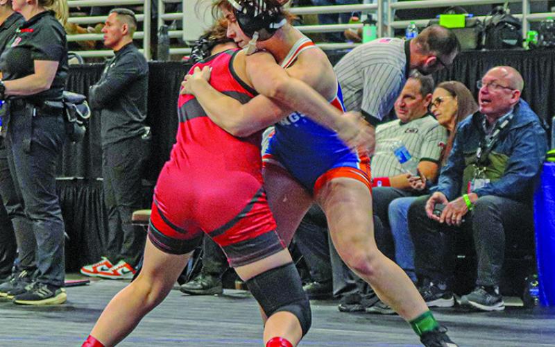 Photo by Blake Peterson Sophomore Lainey Fillmore ties up with her opponent during their match on Friday, February 16.
