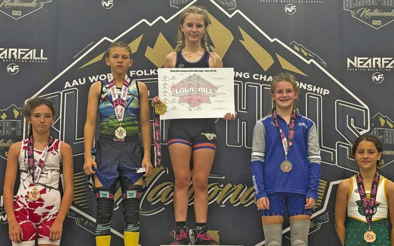 (Courtesy Photo) Gordon resident Brayzee Rawles stands atop the podium at the Black Hills Nationals Girls Glam Slam. Rawles took home the top prize in the 12U 100 lb. bracket. Rawles competed against the best of the best at the event which took place on Saturday, October 11.