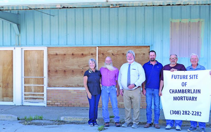 (Photo by Scott Bidroski) A property that has long been empty on the north side of Gordon has new owners. Chamberlain Mortuary purchased the property from Joe and Rosana Kirk and has plans to renovate the building to suit their needs. Pictured in the photo include: (L-R) Rosana Kirk, Joe Kirk, Jeff Chamberlain, Thomas Chamberlain, Harlen Wheeler, and Larry Turnbull.