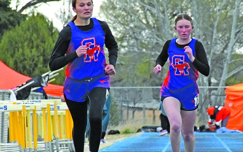 Photo by Melissa Grover Mustang sophomore Ashlyn Dehning and freshman Kynsleigh Krebs both push for the finish line during the Western Trails Conference Track Meet in Morrill on Thursday, April 17.