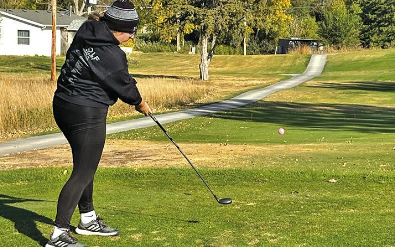 Photo by David Morris Senior Katie Coomes tees off during the State Golf Tournament held on October 16 and 17 in North Platte, Neb.