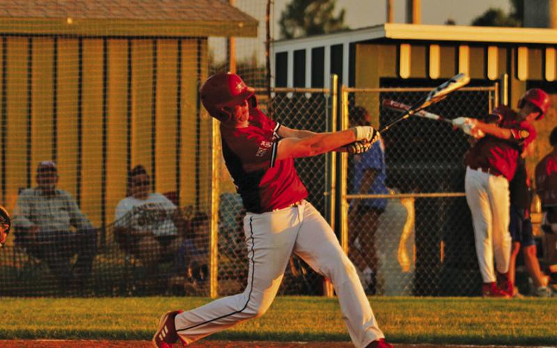 Photo by Megan Heiting Right: Brayden Heiting takes a big swing at a Hot Springs pitch.