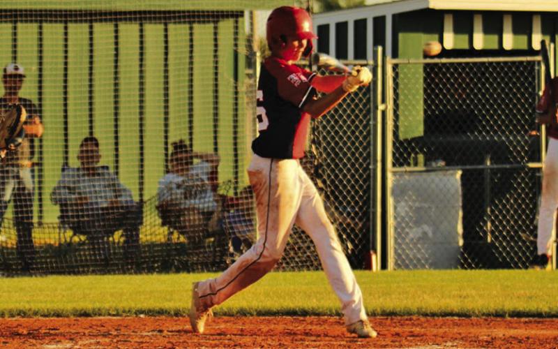 Photo by Megan Heiting Freshman Kannon Leeper squares up a high fastball for a single during a contest at Modisett Ball Park for the Regs.