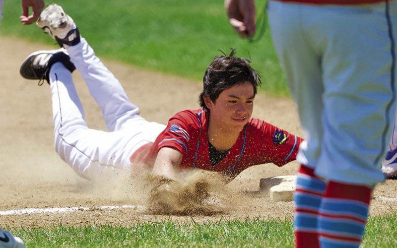 (Photo by Richae Malara) Freshman Kendall Lebeau slides safely into third base during the Gering Tournament this past weekend. Lebeau and the Regulators went 2-2 over the 4 game tourney.