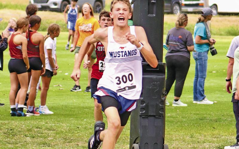 (Photo by Scott Bidroski) Sophomore Robert Moore digs deep on the final stretch of the Panhandle Classic. The Mustang finished in 13th place overall and had a personal best time of 18:24.