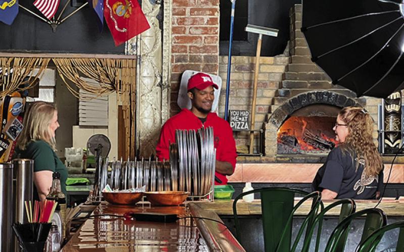Photo by Shontell Roseberry Tosha and Kandy visit with DeAngelo from ABR Roadshow, next to the brick oven at the Twisted Turtle Pub in Rushville.