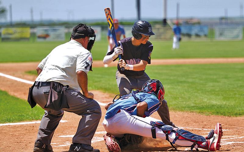 (Photo by Richae Malara) Regulator catcher Braylon Holston smothers the pitch in the dirt, holding the base runners in place. Holston would collect a 2-RBI double in the 10-2 Regulator win.