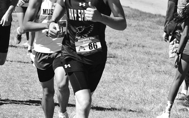 Photo by Chris Heiser Junior Mason Albrecht stays ahead of a few competitors during the Alliance Cross Country Invite on September 21.