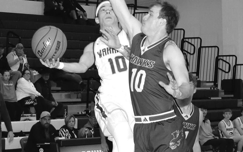 Photo by Taylor Risse, Bennett County Booster Senior Jordyn Anderson goes for the block against the Bennett County shooter. The Hawks would hang on for the win, 68-66.