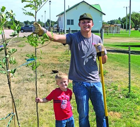 Courtesy Photo Dax Dolezal and Turner Anderson volunteered their time this past weekend to plant trees for the Rushville Tree Board for the Ballpark Beauty Project.