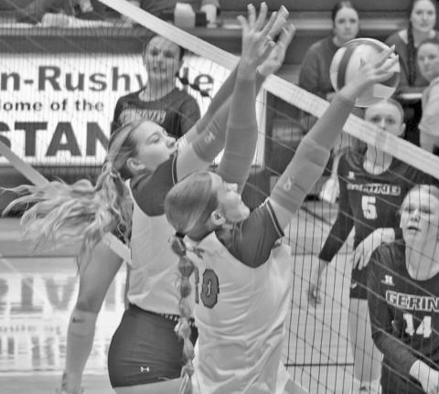 Photo by Michele Heck Mustangs Taleigh Starr and Emma Martins go up for a block against the Gering attackers on October 15.