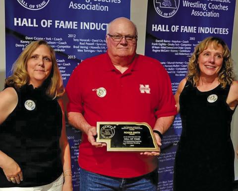 Courtesy Photo Roger Smith’s daughters Stacy Smith Muehling (left) and Laurna Smith Drake (right) were joined by Gordon Wrestling alumni Dan Kling during the Nebraska Scholastic Wrestling Coaches Association Hall of Fame Banquet in which the late Gordon coach was inducted.