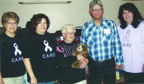 Courtesy Photo Nancy Scherr, Shelley Beguin, Mary & Harold Hupp, and Terrie Jo Gibbons take a photo back in 2008 at the CARE Consignment Auction. Scherr and Gibbons are two of the original three members of the CARE Organization.
