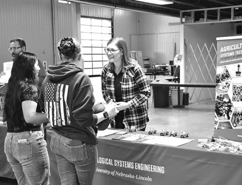 Photo by Chabella Guzman University of Nebraska-Lincoln Jenny Keshwani, a science literacy specialist, chats with students at a November career day in Scottsbluff.