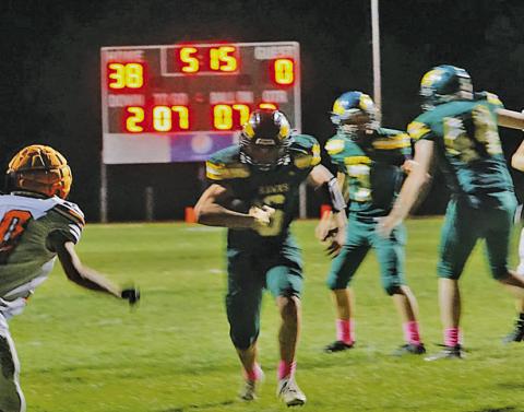 Photo by Michele Heck Sophomore Jaydub Turman scurries through a hole in the defensive line for the score. Turman would account for 4 total touchdowns in the 78-12 Hawks win.