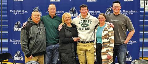 Courtesy Photo St. Thomas More senior and Sheridan County native Marcus Stouffer signed his Letter of Intent to play football at Black Hills State on February 22. Joining Stouffer for the occasion included: (L-R) St. Thomas More Coach Joe Gutierrez, Kelly Stouffer, Barb Stouffer, Marcus Stouffer, Maci Stouffer, and Max Stouffer.