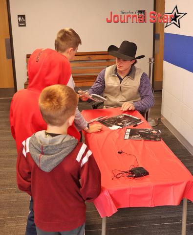 (Photo by Scott Bidroski) Young fans get their poster signed by Gordon native and Professional Bull Rider Conner Halverson on Wednesday, June 4 at the Gordon Theatre.