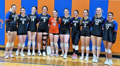 (Photo by Michele Heck) Ten seniors put on the orange and blue for the final time as Mustang Volleyball players. Here is the group pictured after their final home match.