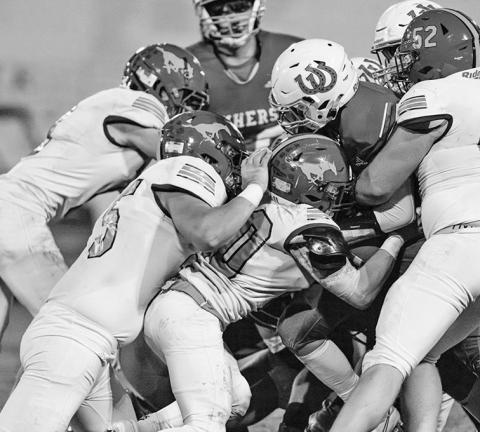 Photo by Morgan Meisenheimer The Mustang defense stops Amherst on fourth down during the 21-13 Mustang win on October 25.