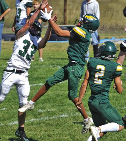 (Photo by Michele Heck) Freshman Arian Mata skies for the interception over the Creek Valley Storm receiver in the Hawks 80-12 win on Friday, September 19.