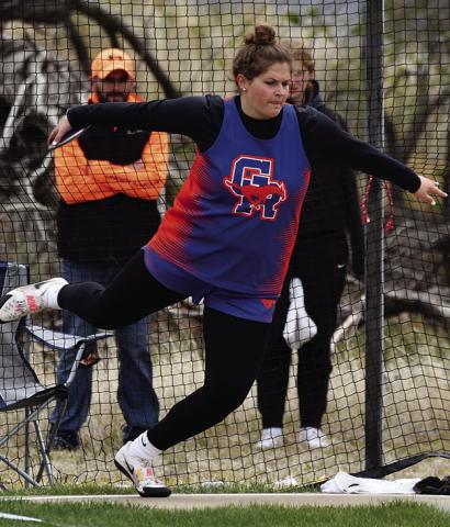 Photo by Melissa Grover McKinley Grover launches the discus for her second gold medal on the day to punch her ticket to the NSAA State Track Meet at Burke Stadium in Omaha, Neb.