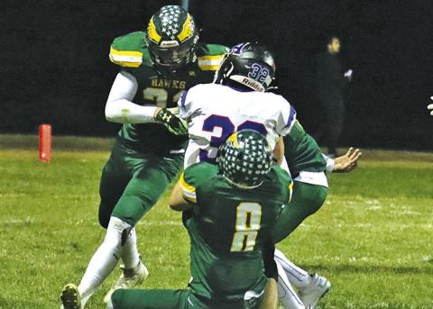 Photo by Scott Bidroski Hawk seniors Talan Smith (#21) and Hunter McDonald (#8) bring down an Arthur County ball carrier during the October 25 contest.