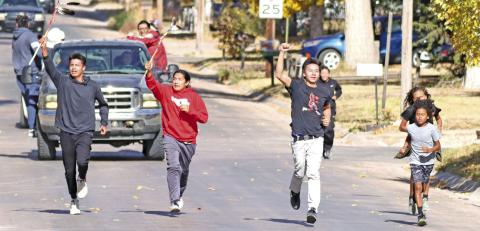 Photo by Scott Bidroski Ketch Big Crow, Cody Two Bulls, Isnala White Bull, and Chevy Cadwell finish the relay run down Oak Street in Gordon on Wednesday, October 23. These young men were part of a group who ran from Pine Ridge, S.D. to Gordon in memory of two young men who died recently in a car accident.