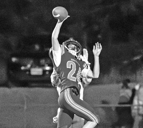 Photo by Morgan Meisenheimer Senior Austin Child elevates to knock away the pass from the Badger receiver.