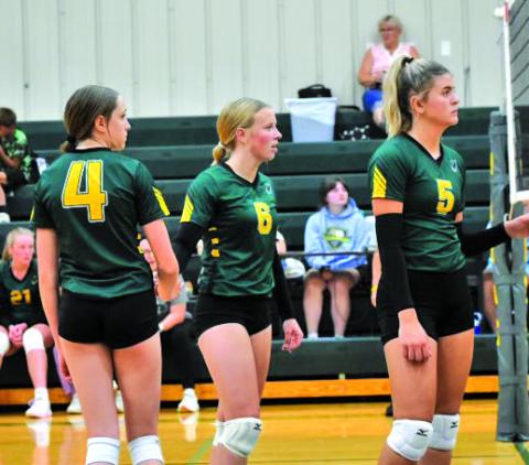 Courtesy Photo Kya Binger, Reese Varvel, and Julia Russell await the serve from Banner County on September 3.