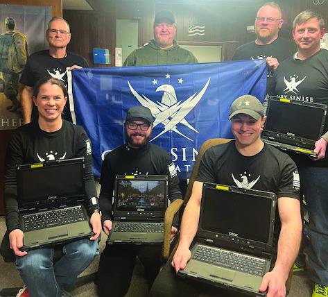 Courtesy Photo Police Chief Clay Heath holds banner for the Gary Sinise Foundation that helped provide funding for some of the new equipment recently purchased for the Gordon PD, including the new rugged G-tech laptops pictured here.