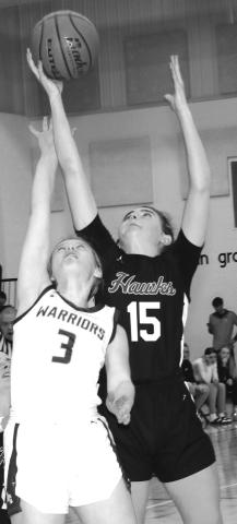 Photo by Taylor Risse, Bennett County Booster Sophomore Julia Russell goes up and over the Warrior defender for a rebound. Russell would finish the contest with 12 rebounds and 17 points.
