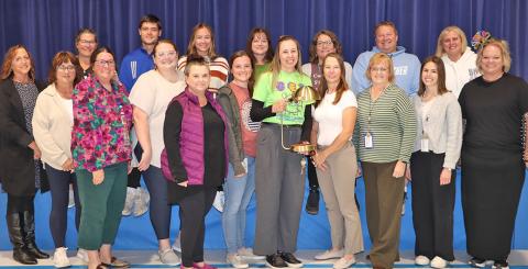 (Photo by Scott Bidroski) Gordon Elementary Principal Robin Johnson (center) takes a photo with her staff at Gordon Elementary on Monday, November 3. Johnson received the Lozier Foundation LIGHTS Outstanding Principal Award on Thursday, October 30 in Omaha. Johnson received $25,000 in monies to help improve GES along with a commemorative lamp, which is displayed above.