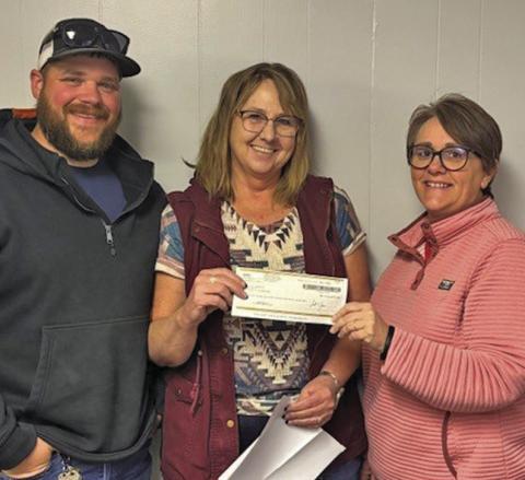 (Courtesy Photo) City of Rushville Superintendent in Training Logan Colwell (left) and Rushville Mayor Amanda Haller (right) receive a check for $14,273.50 from Security First Insurance Managing Agent Phyllis Lindsey.