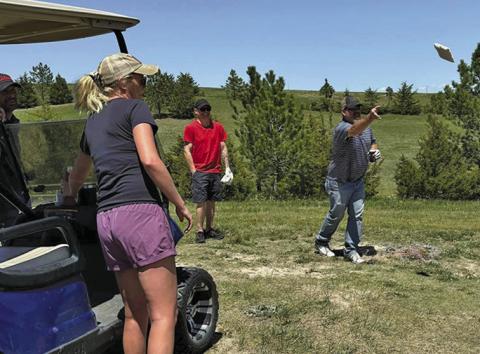 Photo by Lisa Merritt Brant Buettner, Lexi Buettner and David Galyen watch as Erik Persons tosses his cornhole bag at the Hay Springs Golf Course.