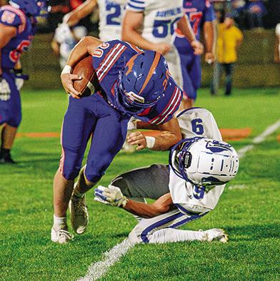 Photo by Morgan Meisenheimer Senior Kyler Vincent runs over a Gibbon defender en route to a big gain for the Mustangs. Vincent finished his evening with 124 yards and 2 touchdowns.