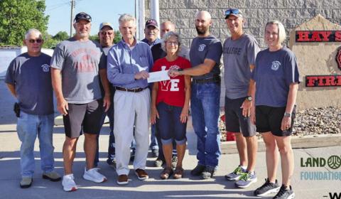 Photo by On Thursday, June 19, members of the Hay Springs Fire Department along with representatives from WESTCO presented a $40,000 check in honor of the late Randy Turman. Those pictured included: (L-R) Tim Fetter, Jeff Turman, Jerry Turman, David Briggs, Keith Kearns, Everett Langford, Betty Turman, Cole Wyatt, Ryan Turman, and Holly Scherbarth.