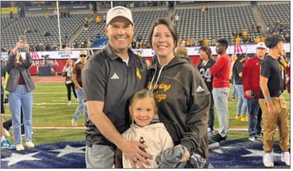 Shannon Moore (left) takes a photo with his wife Lindsay (right) and daughter Mackenzie (center) following the University of Wyoming’s bowl win over Toledo in 2023. The Cowboys took down the Rockets 16-15 in the Barstool Sports Arizona Bowl with Moore on staff as the Tight End and Fullbacks Coach.
