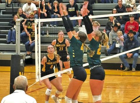 Photo by Jim Varvel Senior Mya Turman and sophomore Devyn Young go up for the block against Mullen on Friday, Sept. 5.