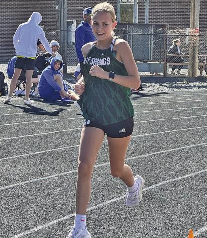 (Photo by Jessie Anderson) Freshman Tabby Schiaffo rounds the corner during the Mitchell Invite on Thursday, April 9.
