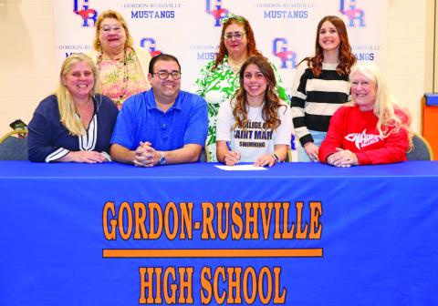 Photo by Scott Bidroski Gordon-Rushville High School senior Valeria Benitez-Socarres signed her Letter of Intent to swim collegiately at the College of Saint Mary’s on Monday, March 23. Benitez-Socarres was joined by her family and coach for the big event. Those pictured include: Sylmarie Socarres, Arelis Quintones, Jose Benitez, Arelis Benitez, Valeria Benitez-Socarres, Fabiola Benitez-Socarres, and Barb McCartney.