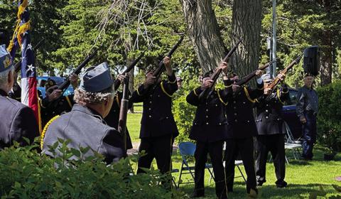 Photo by Heidi Beguin The Color Guard from Rushville Post #161 fires off a 21gun salute for the Memorial Day services at the Rushville Cemetery.